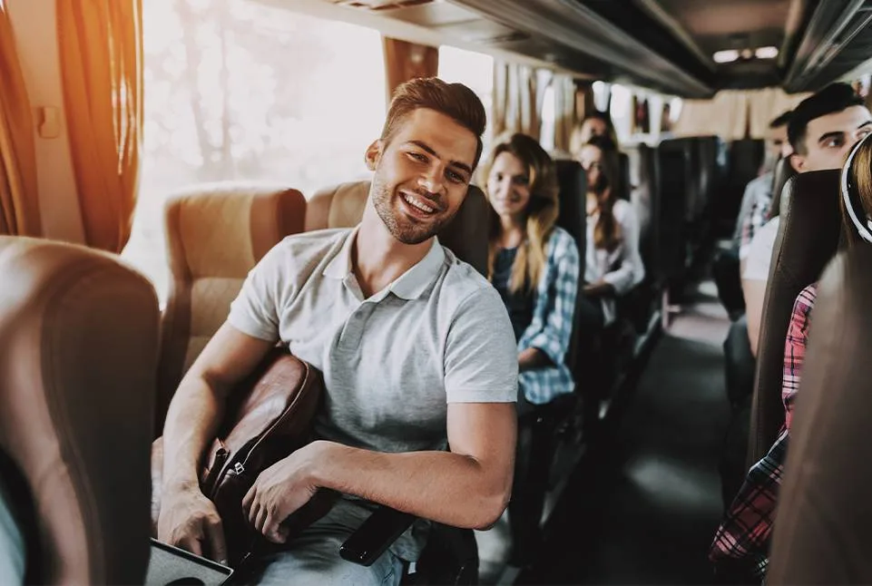 Passengers seated inside a shuttle bus.